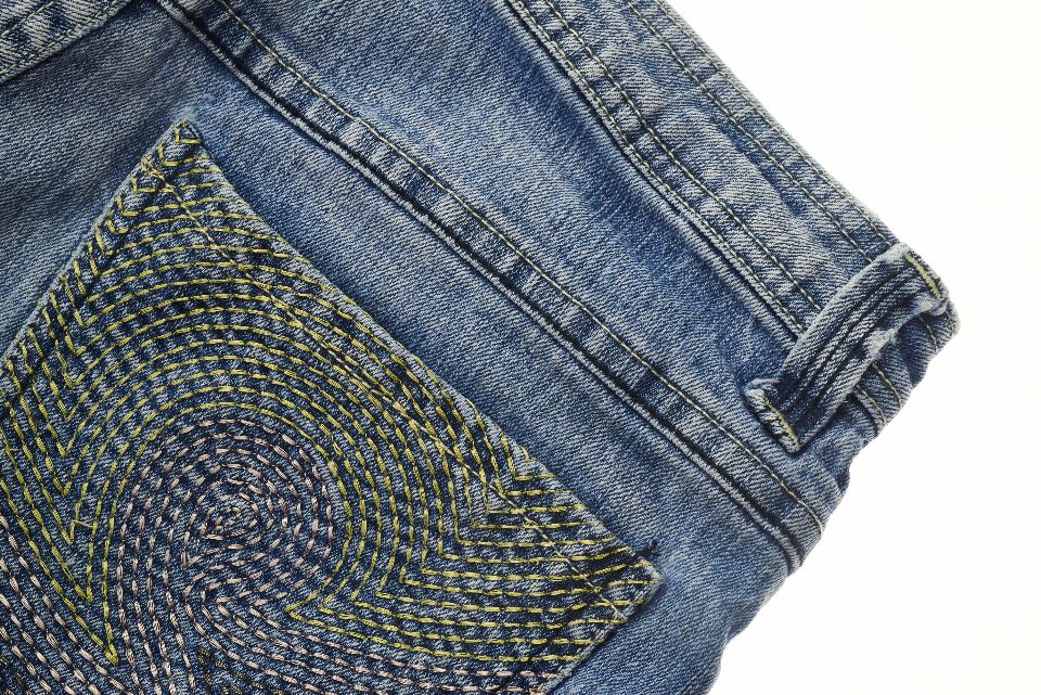 A denim back pocket decorated with hand embroidery