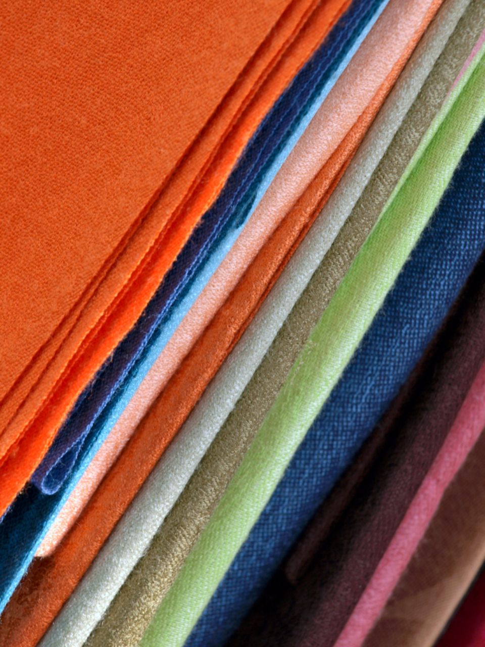 Neatly stacked felt fabric sheets in a rainbow of colors