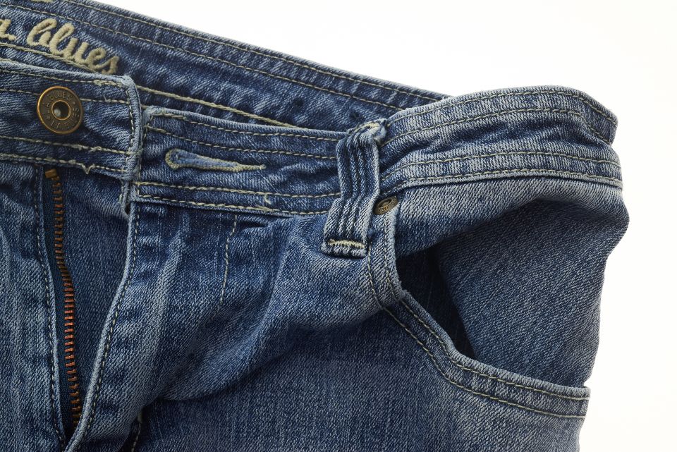 A pair of worn blue jeans ready to be upcycled