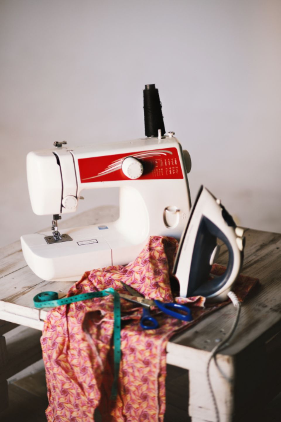 A small sewing station with a sewing machine and iron