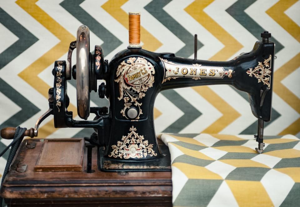 A vintage black sewing machine with gold detailing
